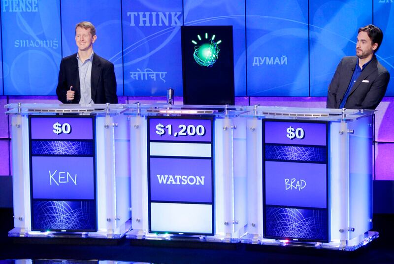 “Jeopardy!” champions Ken Jennings, left, and Brad Rutter look on as an IBM computer called “Watson” beats them to the buzzer to answer a question during a practice round of the “Jeopardy!” quiz show.