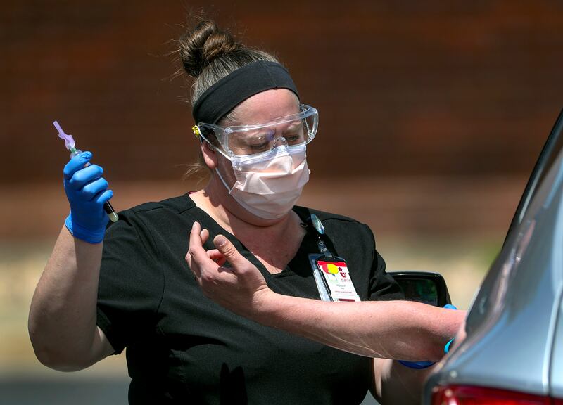Holley Bryan, a medical assistant with University of Utah Health, draws a patient’s blood at a testing facility in Park City on Wednesday, May 6, 2020.