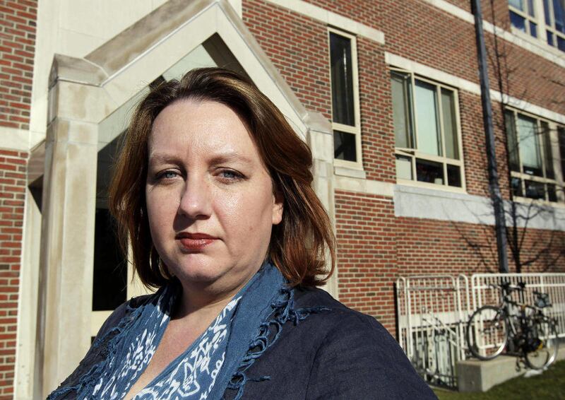 FILE - In this Jan. 24, 2012 file photo, Carrie Twomey, wife of former IRA member Anthony McIntyre, stands outside a building where a federal court hearing was being held at the Boston College Law School in Newton, Mass. McIntyre is an ex-IRA gunman who c