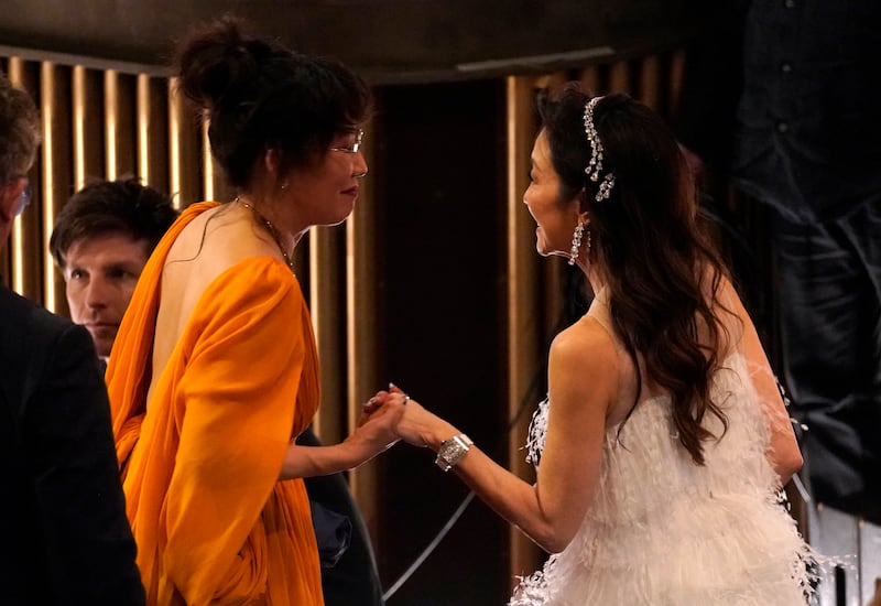 Sandra Oh, left, and Michelle Yeoh are seen in the audience at the Oscars on Sunday, March 12, 2023, in Los Angeles.