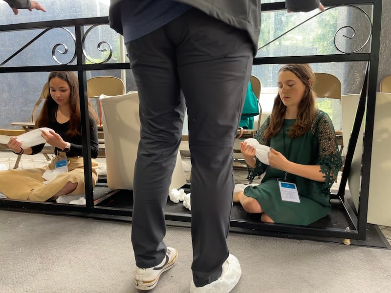 Sydney Beck, left, 16, and Louisa Groesbeck, 15, help visitors at the Washington D.C. Temple open house on May 27, 2022.