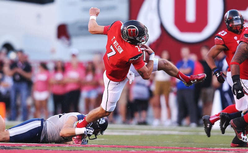 Utah Utes quarterback Travis Wilson is tackled by Utah State linebacker Nick Vigil, Sept. 11, 2015, at Rice-Eccles Stadium.