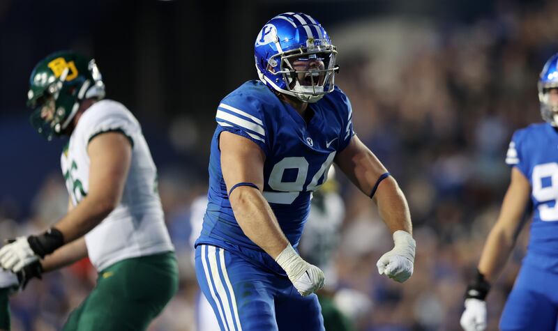 Brigham Young Cougars defensive lineman John Nelson (94) celebrates a sack on Baylor Bears quarterback Blake Shapen.