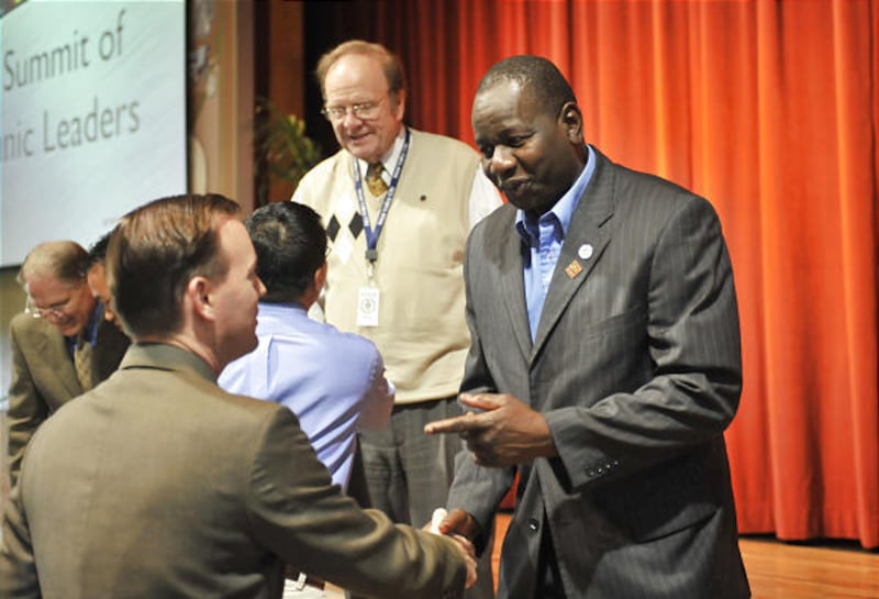Mayor Mike Winder, left, shakes hands with Amadou Niang.