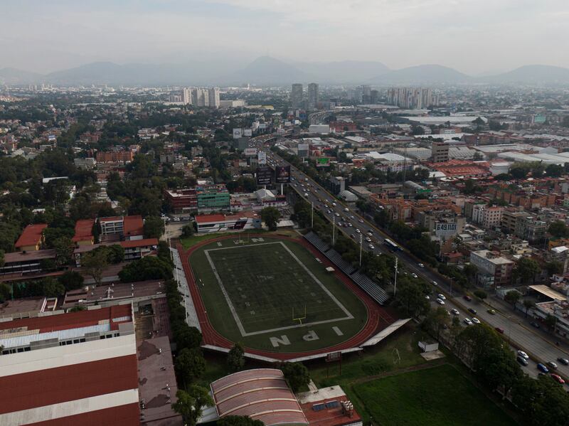 The football field sits empty at the Polytechnic National Institute high school, closed amid the new coronavirus on the first day of classes in Mexico City, Monday, Aug. 24, 2020.