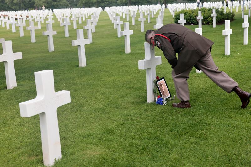 World War II history enthusiast Arnauld Villalard visits a cross at the U.S. cemetery of Colleville-sur-Mer, Normandy.