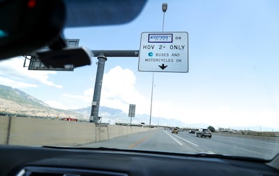 Daniel Haslam travels in the express lane on I-15 in Lehi as he travels from his job at a tech company at Thanksgiving Point to Utah Valley University to attend a graduate school class on Thursday, July 12, 2018. Haslam has used the express pass system to