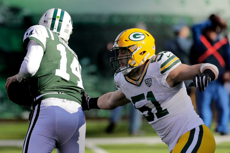 New York Jets quarterback Sam Darnold (14) scrambles as Green Bay Packers linebacker Kyler Fackrell (51) moves in for the sack during the first half of an NFL football game, Sunday, Dec. 23, 2018, in East Rutherford, N.J.