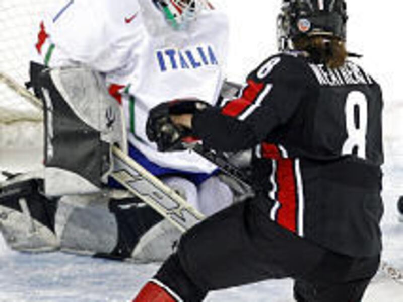 Canada's Katie Weathrston scores one of her team's 16 \— count 'em, <I>16 </I> \— goals on Italy goaltender Luana Frasnelli in the preliminary round of Olympic play Saturday.