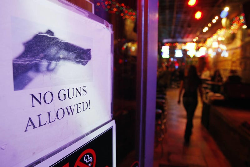 A sign declaring that no guns are permitted is posted on the door of Tootsie's Orchid Lounge in on Thursday, Dec. 10, 2009 in Nashville, Tenn. In Tennessee, properly licensed handgun owners won the right to carry their weapons into bars, restaurants that