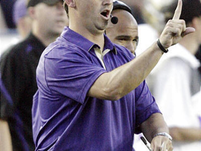 Washington coach Steve Sarkisian signals a play to the Huskies' offense from the sideline during Saturday's game.