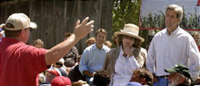 From right, Sen. John Kerry, Kerry's wife, Teresa Heinz Kerry, and vice presidential nominee Sen. John Edwards listen to a question from a hog farmer near Smithville.