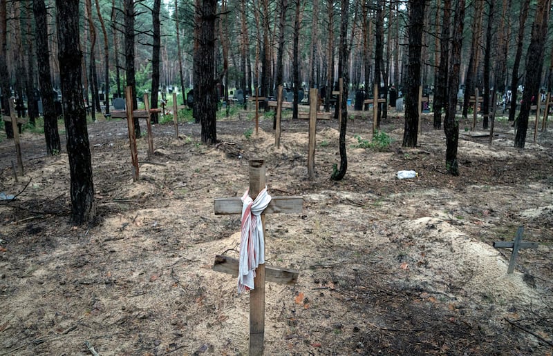 Unidentified graves of civilians and Ukrainian soldiers in a cemetery, in the recently retaken area of Izium, Ukraine.