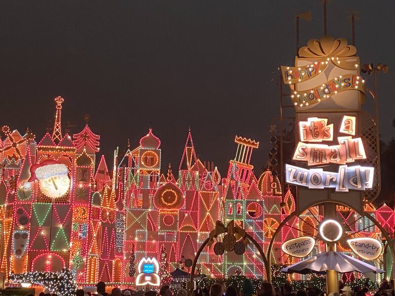 The Disneyland attraction “it’s a small world” is adorned in bright lights for its holiday season overlay.