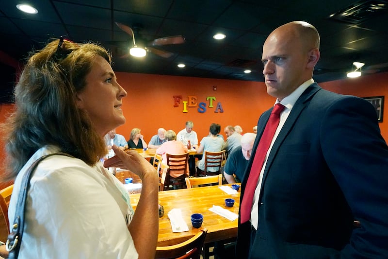 Former Navy pilot Michael Cassidy speaks to potential voter Heather Berry.