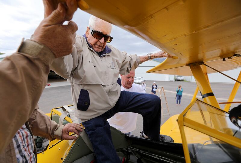 Retired Air Force Lt. Col. Bill Willis, 97, climbs into a Boeing-Stearman at the Morgan County Airport in Morgan before a flight on Friday, June 14, 2019.
