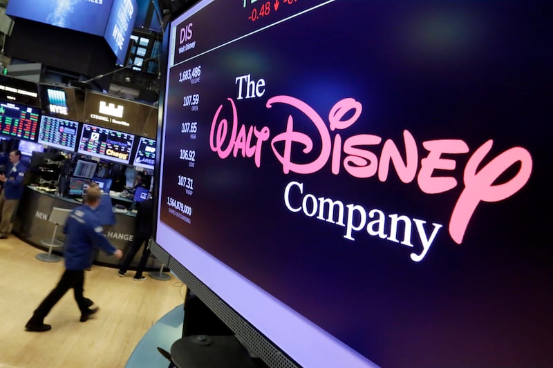 In this Monday, Aug. 7, 2017, file photo, The Walt Disney Co. logo appears on a screen above the floor of the New York Stock Exchange.