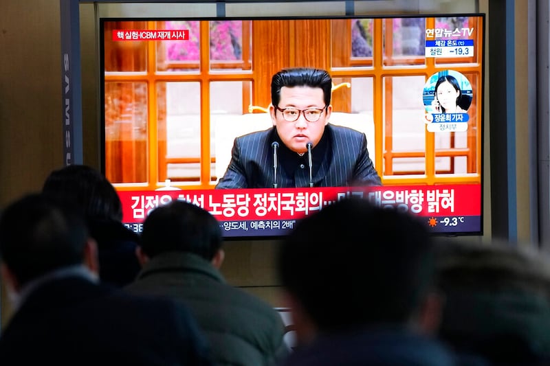 People watch a TV showing an image of North Korean leader Kim Jong Un shown during a news program.