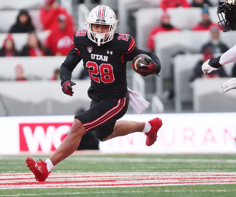 Utah Utes safety Sione Vaki (wearing black) runs against the Colorado Buffaloes