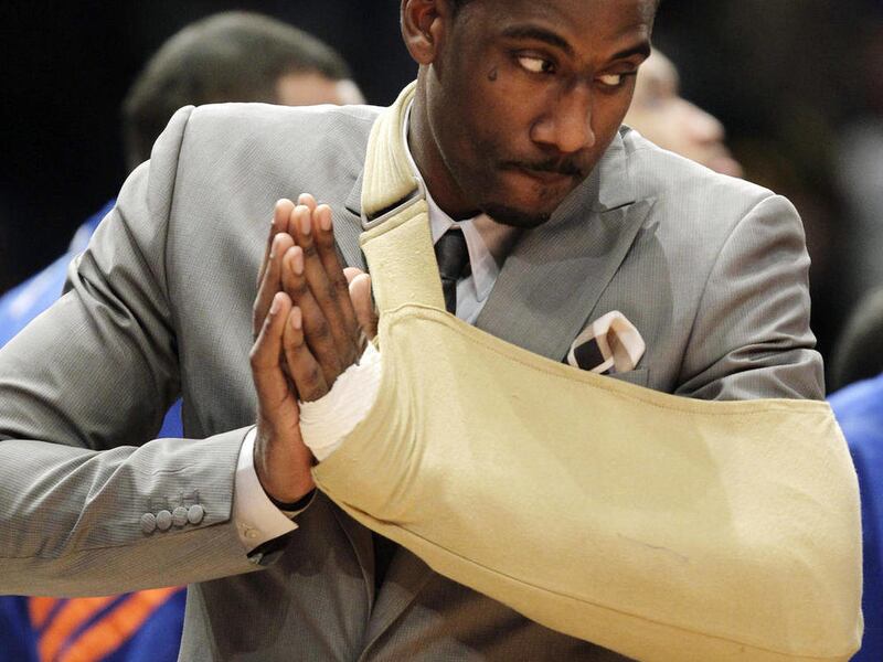In this Thursday, May 3, 2012, photo, New York Knicks forward Amare Stoudemire watches from the baseline with his arm in a sling before Game 3 of an NBA basketball first-round playoff series at Madison Square Garden in New York. Stoudemire sat the game ou