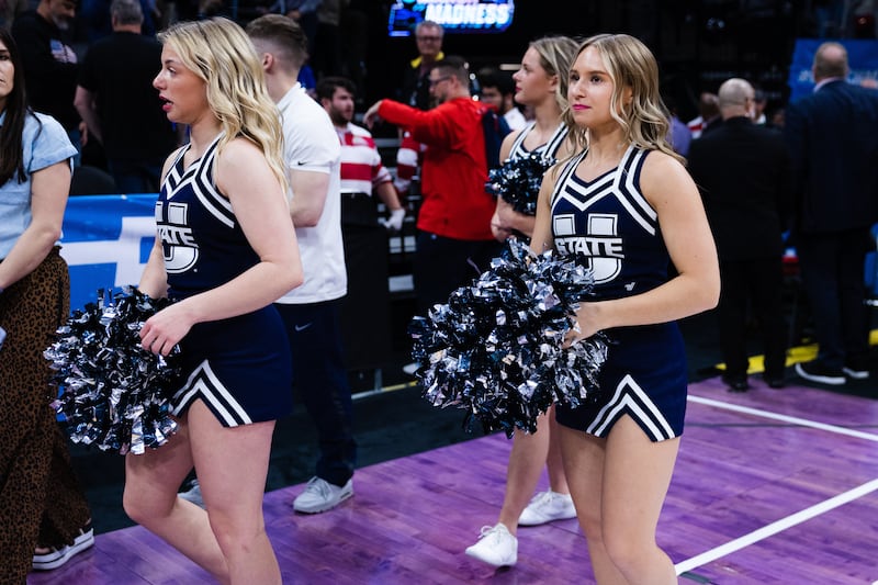 Utah State cheerleaders leave the court during the first round of the NCAA men’s basketball tournament between Utah State and Missouri at Golden One Arena in Sacramento on March 16, 2023.