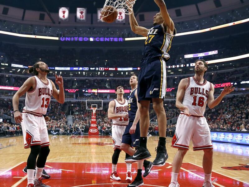 Utah Jazz center Rudy Gobert (27) dunks the ball as Chicago Bulls Joakim Noah (13), Kirk Hinrich (12) Jazz Joe Ingles (2), and Bulls Pau Gasol watch, during the first half of an NBA basketball game Wednesday, Jan. 7, 2015, in Chicago. (AP Photo/Charles R