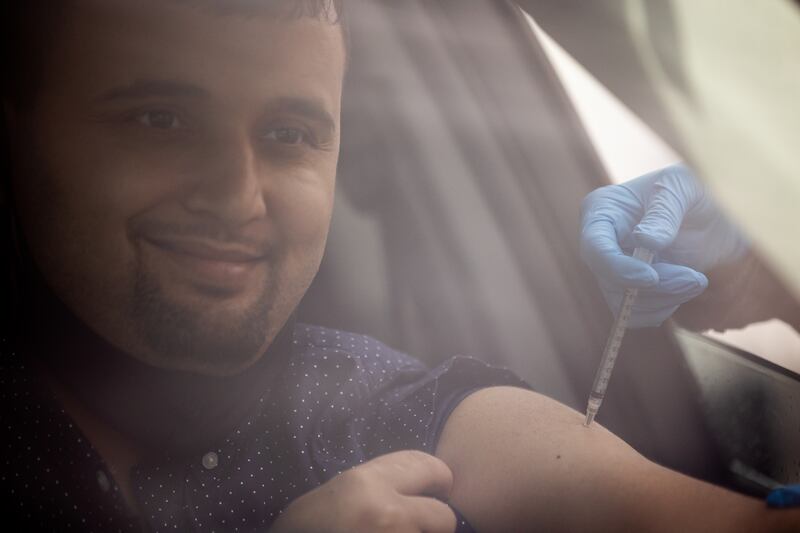 Pacha Sayedi smiles as he receives a dose of the Pfizer-BioNTech COVID-19 vaccine during a vaccination event at the Khadeeja Islamic Center and Mosque in West Valley City on Friday, March 26, 2021.