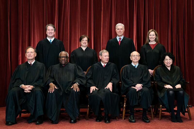 In this April 23, 2021, file photo, members of the Supreme Court pose for a group photo at the Supreme Court in Washington.