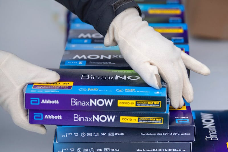 Youngstown City Health Department worker Faith Terreri grabs two at-home COVID-19 test kits.