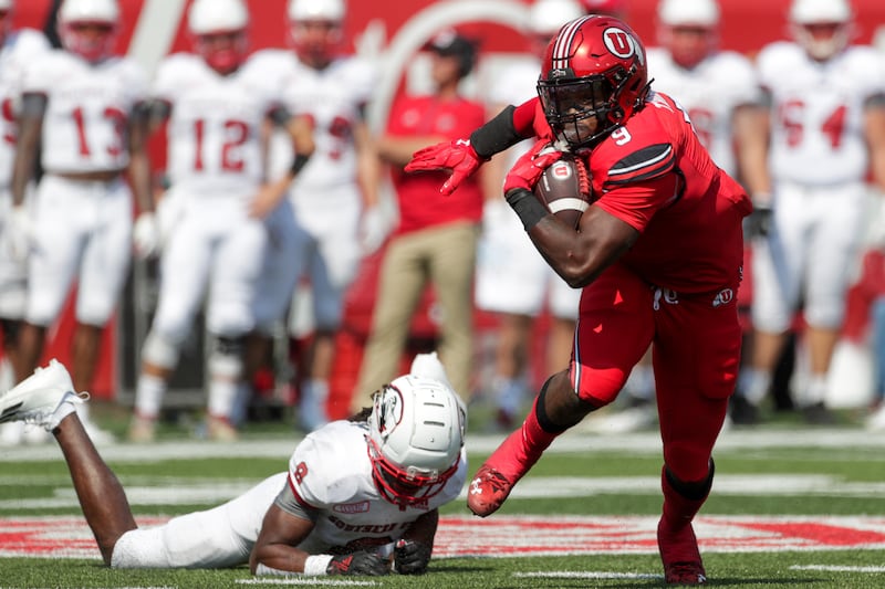 Utah’s Tavion Thomas dodges a tackle during game against Southern Utah in Salt Lake City on Saturday, Sept. 10, 2022.
