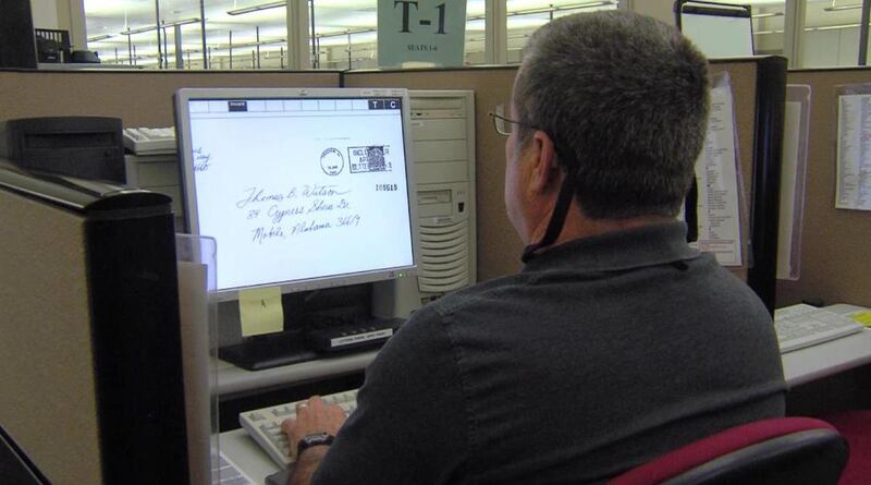 Dan McCoy is one of about 1,000 workers at the Salt Lake Remote Encoding Center who figures out where indecipherable mail and poorly addressed packages are supposed to go. Due to a privacy issue, the image on his screen is a fake envelope used for trainin