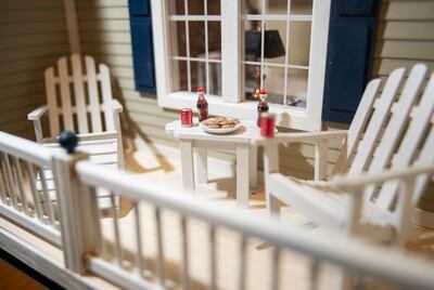 Larry Elkins shows a dollhouse he built matching the dream home he and his late wife Linda had planned to build as he talks about their life together and their family on Wednesday, March 27, 2019.