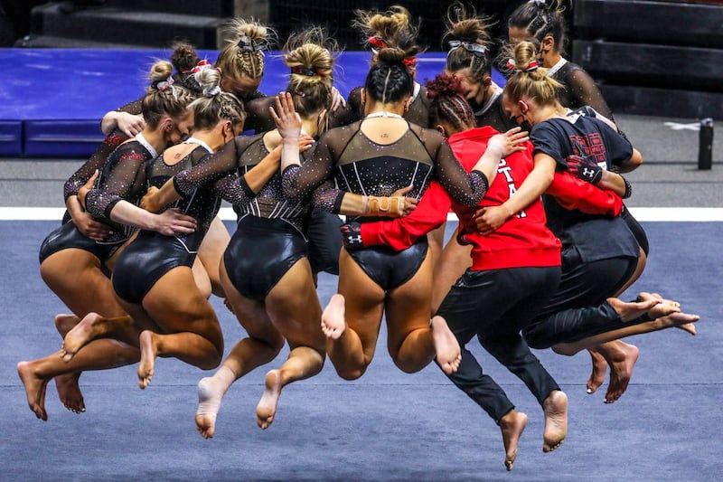 Utah’s gymnasts huddle as Utah and UCLA compete in a gymnastics meet at the Huntsman Center.