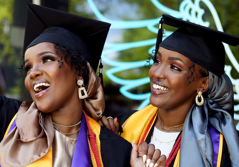 Sisters Asma Dahir and Anisa Dahir take photos prior to commencement at Westminster College.