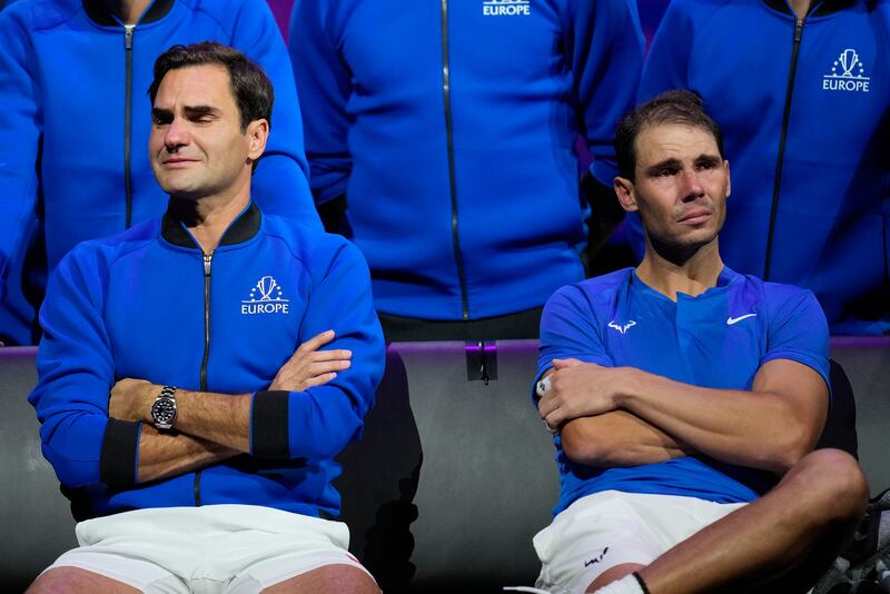 An emotional Roger Federer, left, sits alongside his playing partner Rafael Nadal after their Laver Cup doubles match Sept. 23, 2022.