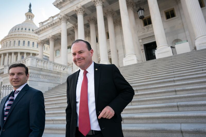 Sen. Mike Lee, R-Utah, right, leaves a private GOP lunch meeting at the Capitol in Washington, Thursday, Dec. 2, 2021.