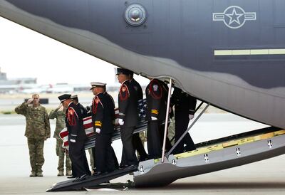 Members of the Draper City Fire Department and Unified Fire Authority Honor Guard carry the casket of Draper Battalion Chief Matt Burchett to a hearse after it was transported from California to Utah in a C130-J by the California Air National Guard. The C