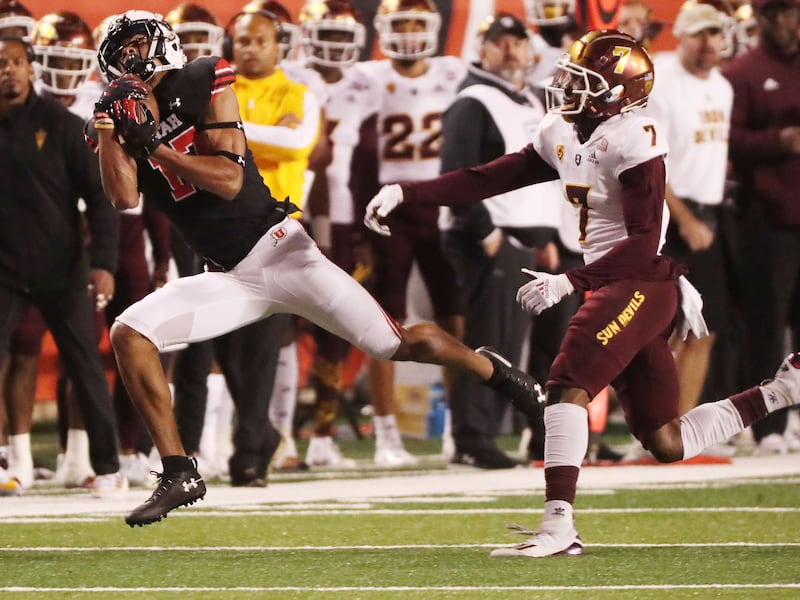 Utah wide receiver Devaughn Vele makes a catch over ASU defensive back Timarcus Davis in Salt Lake City, Oct. 16, 2021.
