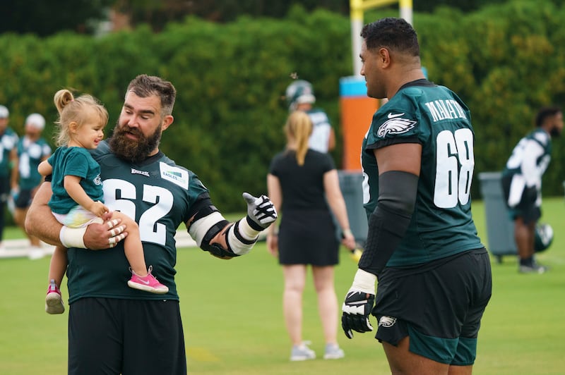 Philadelphia Eagles center Jason Kelce shows off his daughter to offensive tackle Jordan Mailata, during practice, Thursday, July 29, 2021.