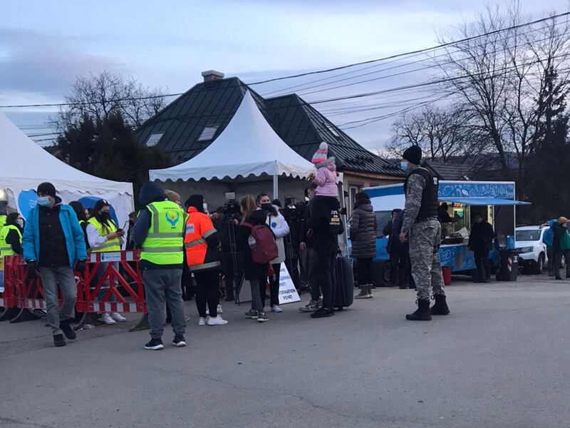 Members of The Church of Jesus Christ of Latter-day Saints in Romania volunteer to cut fabric to provide blankets for refugees.