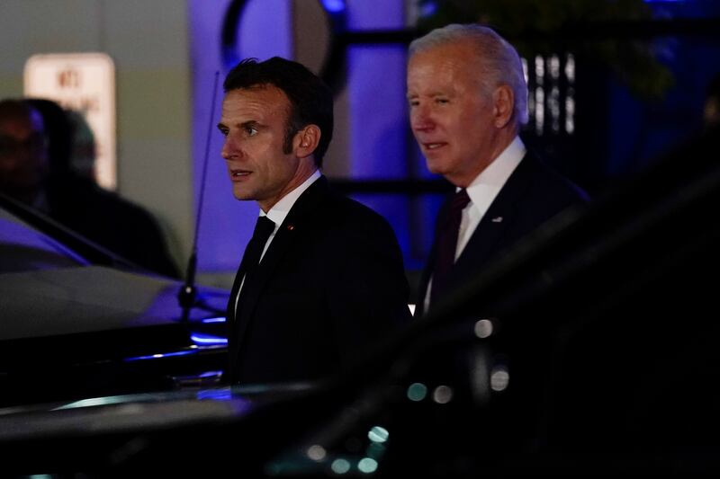 President Joe Biden and French President Emmanuel Macron depart after eating dinner at Fiola Mare in Washington, Wednesday, Nov. 30, 2022.