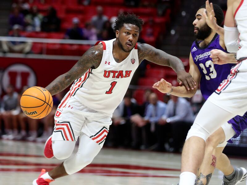 Utah Utes guard David Jenkins Jr. (1) drives against Westminster’s Jarrett Jordan at the Huntsman Center in Salt Lake City on Thursday, Nov. 4, 2021.