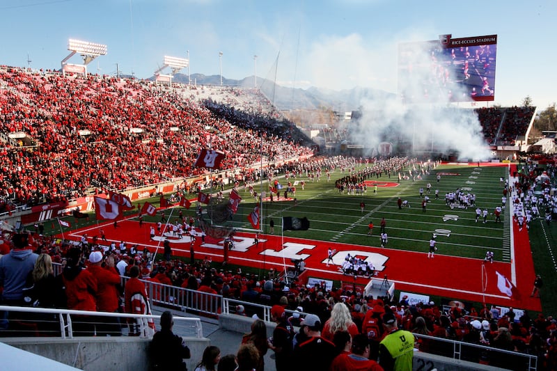 The Utah Utes run onto the field before a college football game against Washington State at Rice-Eccles Stadium.