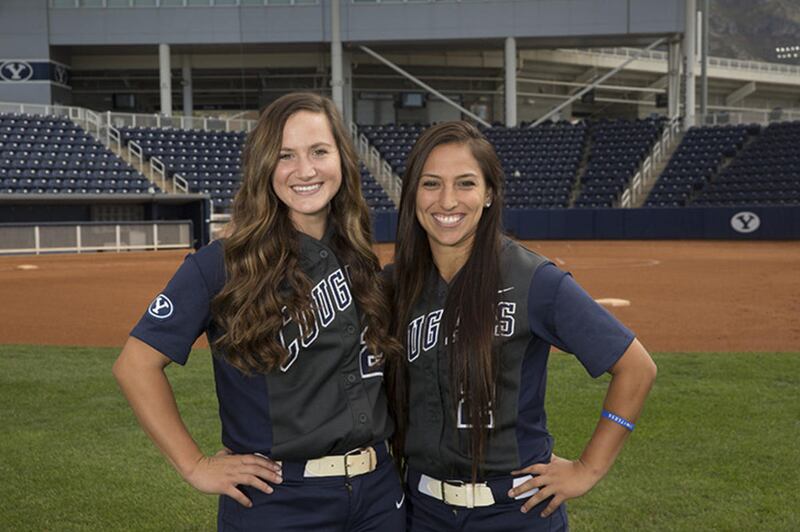 Seniors Coco Tauali'i Bond (left) and Gordy Bravo (right) pose together on the field.