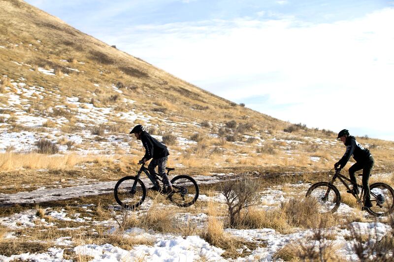 Izik Service and A.E. Silver, of Sugar House, take advantage of the dry conditions of the Bonneville Shoreline Trail during a mountain bike ride in Salt Lake City on Wednesday, Jan. 3, 2018.