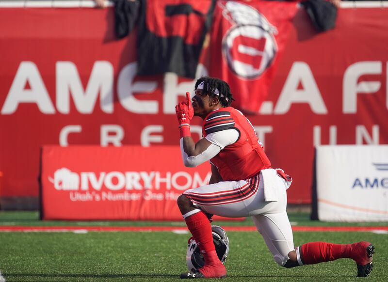 Utah running back Tavion Thomas points upward before game against Colorado at Rice-Eccles Stadium in Salt Lake City.
