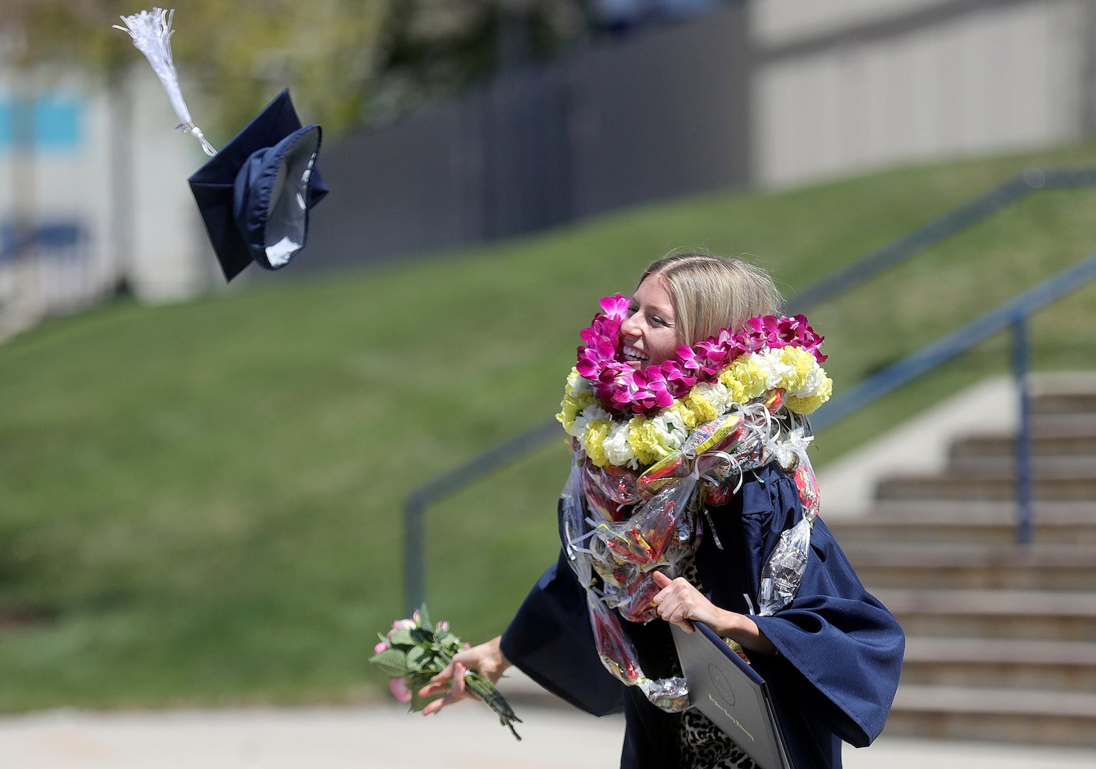 Audrey Cope throws her cap in the air after BYU’s virtual graduation ceremony in April 2021.