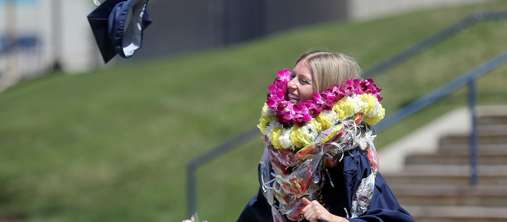 Audrey Cope throws her cap in the air after BYU’s virtual graduation ceremony in April 2021.