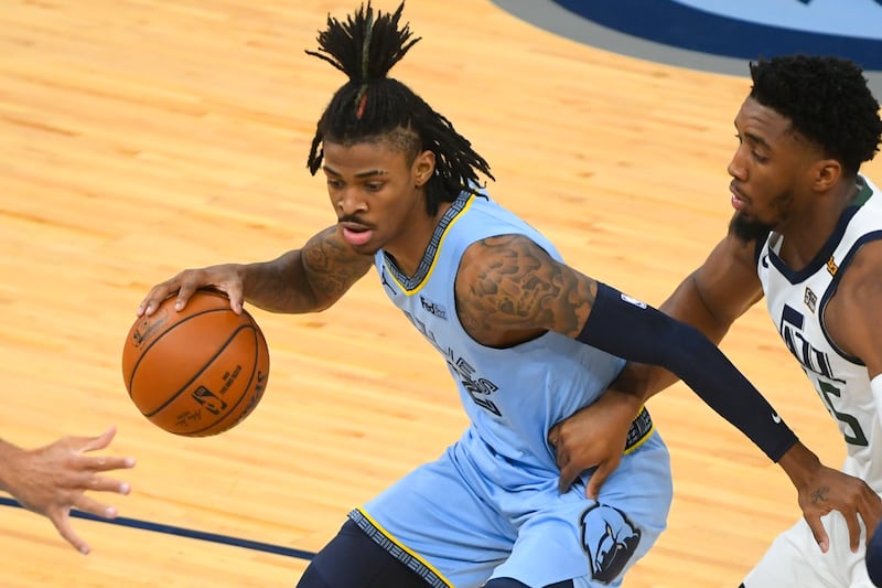 Memphis Grizzlies guard Ja Morant is guared by Utah Jazz guard Donovan Mitchell, right.