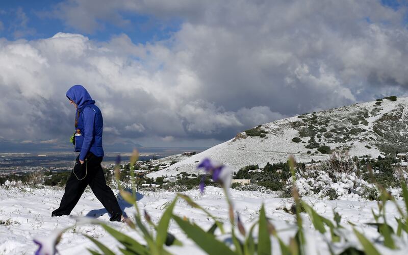 Hannah Gordon, of Salt Lake City, walks in the snow on the Bonneville Shoreline Trail in Salt Lake City on Wednesday, May 17, 2017. A cold front arrived early Wednesday, bringing 4-8 inches of snow to the benches and mountains above 6,500 feet.
